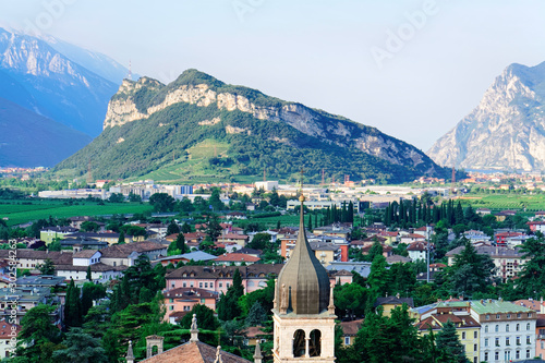 Fototapeta Naklejka Na Ścianę i Meble -  Landscape with Church Santa Maria Assunta on rock at Sarca Valley near Garda lake of Trentino in Italy. Scenery with Cathedral on mountain of Arco town in Trento near Riva del Garda