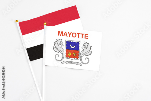 Mayotte and Egypt stick flags on white background. High quality fabric, miniature national flag. Peaceful global concept.White floor for copy space.