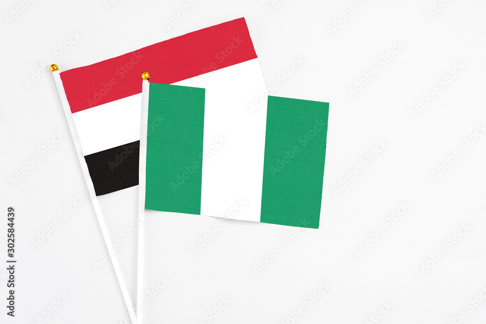Nigeria and Egypt stick flags on white background. High quality fabric, miniature national flag. Peaceful global concept.White floor for copy space. Nigeria and Egypt stick flags on white background. High quality fabric, miniature national flag. Peaceful global concept.White floor for copy space.