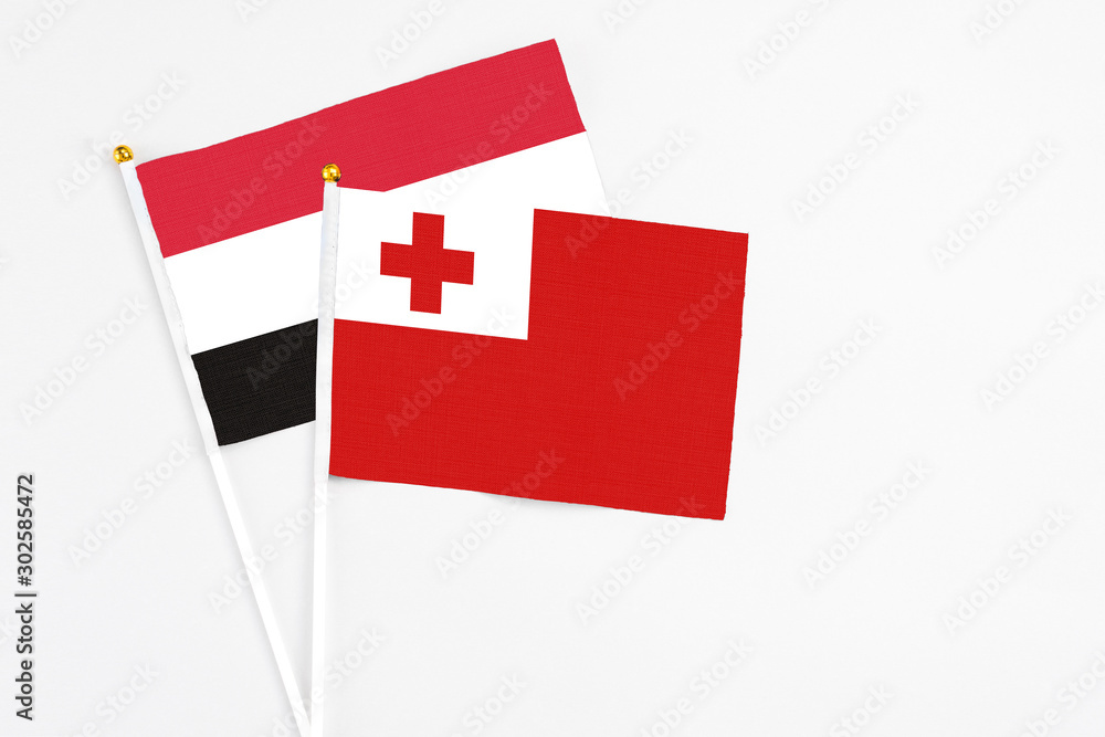 Tonga and Egypt stick flags on white background. High quality fabric, miniature national flag. Peaceful global concept.White floor for copy space.