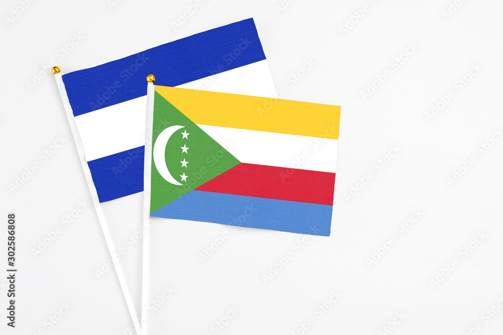 Comoros and El Salvador stick flags on white background. High quality fabric, miniature national flag. Peaceful global concept.White floor for copy space. Comoros and El Salvador stick flags on white background. High quality fabric, miniature national flag. Peaceful global concept.White floor for copy space.