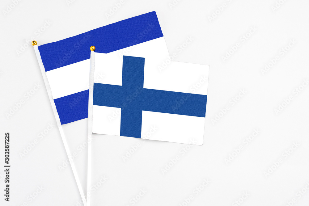 Finland and El Salvador stick flags on white background. High quality fabric, miniature national flag. Peaceful global concept.White floor for copy space. Finland and El Salvador stick flags on white background. High quality fabric, miniature national flag. Peaceful global concept.White floor for copy space.