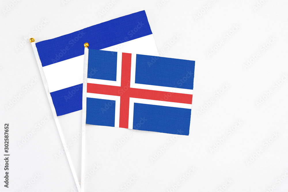 Iceland and El Salvador stick flags on white background. High quality fabric, miniature national flag. Peaceful global concept.White floor for copy space.