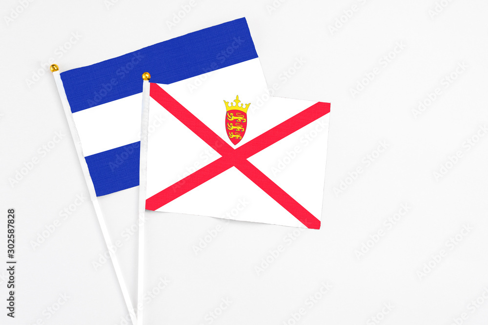 Jersey and El Salvador stick flags on white background. High quality fabric, miniature national flag. Peaceful global concept.White floor for copy space. Jersey and El Salvador stick flags on white background. High quality fabric, miniature national flag. Peaceful global concept.White floor for copy space.