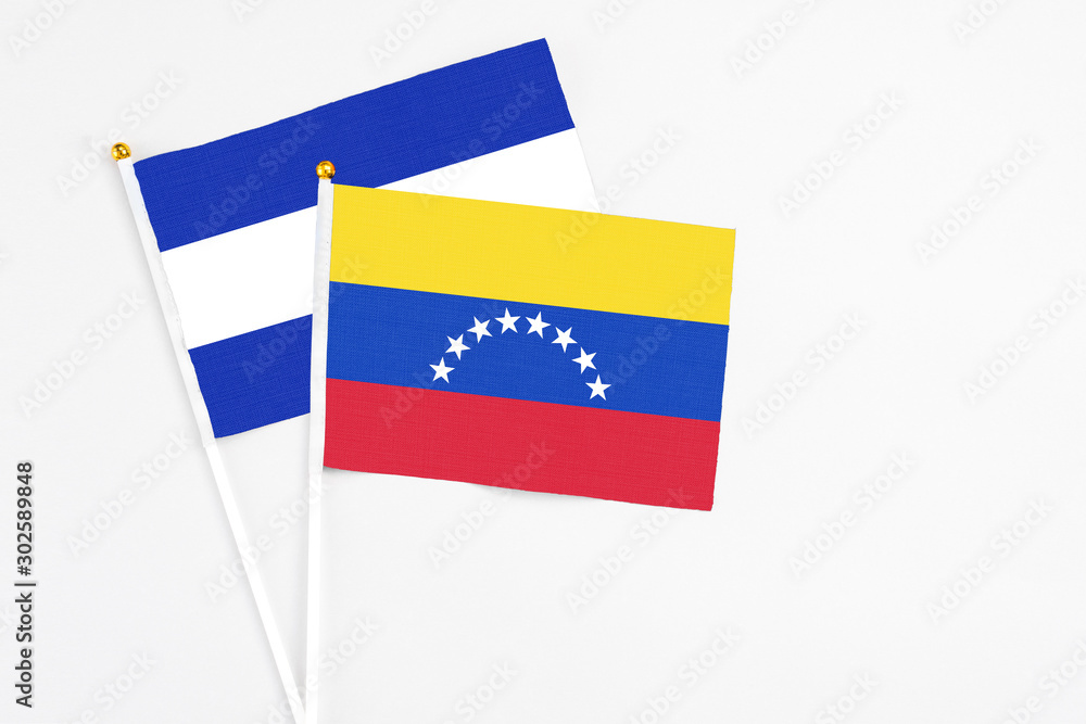 Venezuela and El Salvador stick flags on white background. High quality fabric, miniature national flag. Peaceful global concept.White floor for copy space. Venezuela and El Salvador stick flags on white background. High quality fabric, miniature national flag. Peaceful global concept.White floor for copy space.