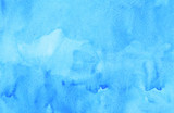 Watercolor light blue liquid background texture hand painted. Aquarelle sky blue abstract backdrop. Stains on paper.