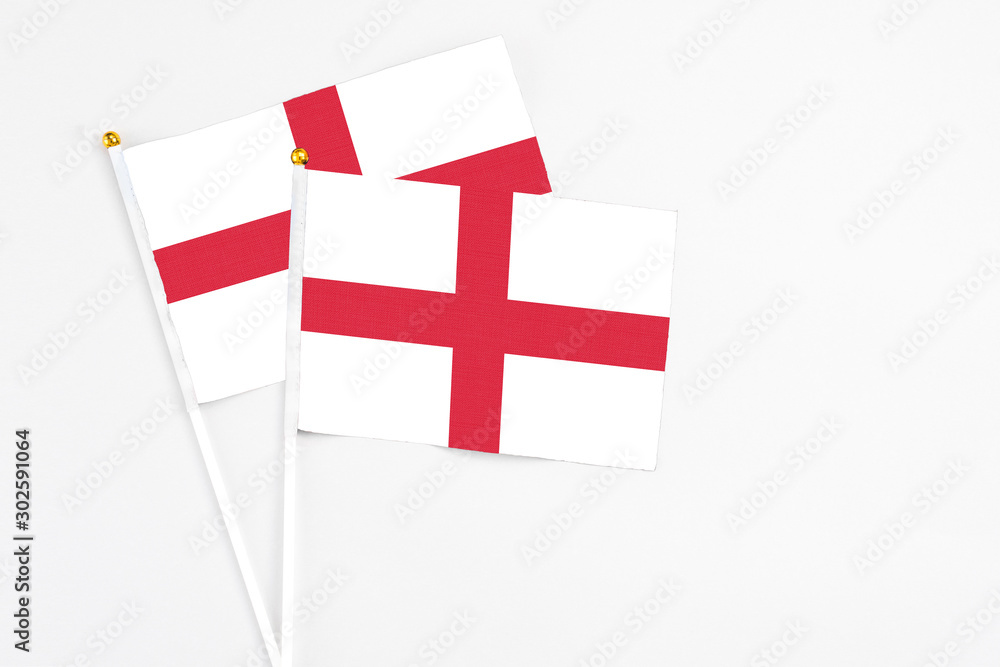 England and England stick flags on white background. High quality fabric, miniature national flag. Peaceful global concept.White floor for copy space.