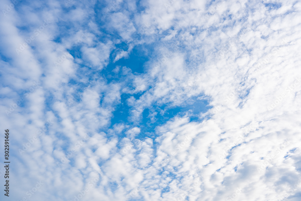 White clouds over blue sky background