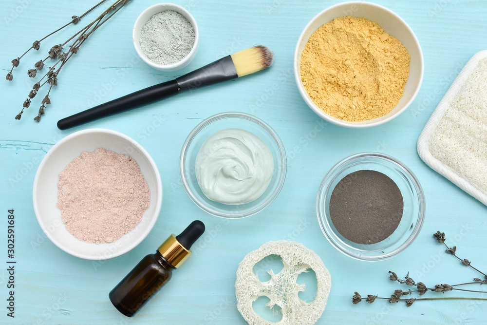 Green, black, yellow, pink clay and cosmetic oil for facial mask, natural skin treatment, flat lay. Green, black, yellow, pink clay and cosmetic oil for facial mask, natural skin treatment, flat lay.