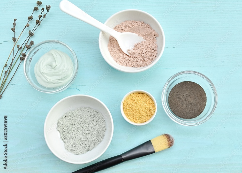Different cosmetic clay, facial mask in bowls, natural skin treatment, top view. Different cosmetic clay, facial mask in bowls, natural skin treatment, top view.