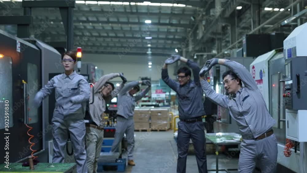 Chinese engineers stretching in factory,HD