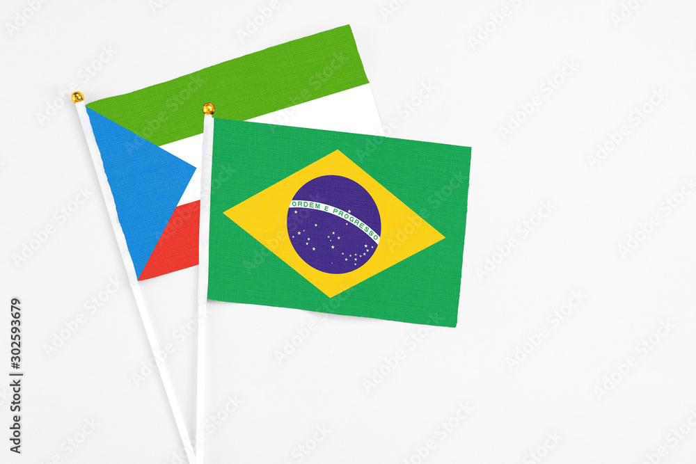 Brazil and Equatorial Guinea stick flags on white background. High quality fabric, miniature national flag. Peaceful global concept.White floor for copy space.