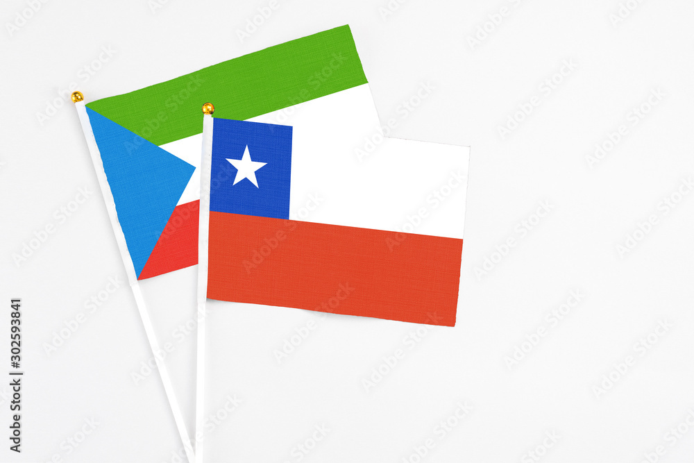 Chile and Equatorial Guinea stick flags on white background. High quality fabric, miniature national flag. Peaceful global concept.White floor for copy space. Chile and Equatorial Guinea stick flags on white background. High quality fabric, miniature national flag. Peaceful global concept.White floor for copy space.