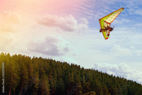 Hang glider flying in the blue sky. Vacation concept photo