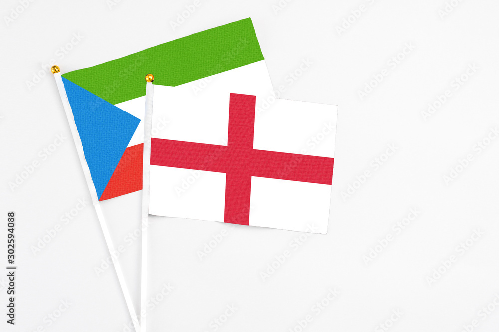 England and Equatorial Guinea stick flags on white background. High quality fabric, miniature national flag. Peaceful global concept.White floor for copy space.