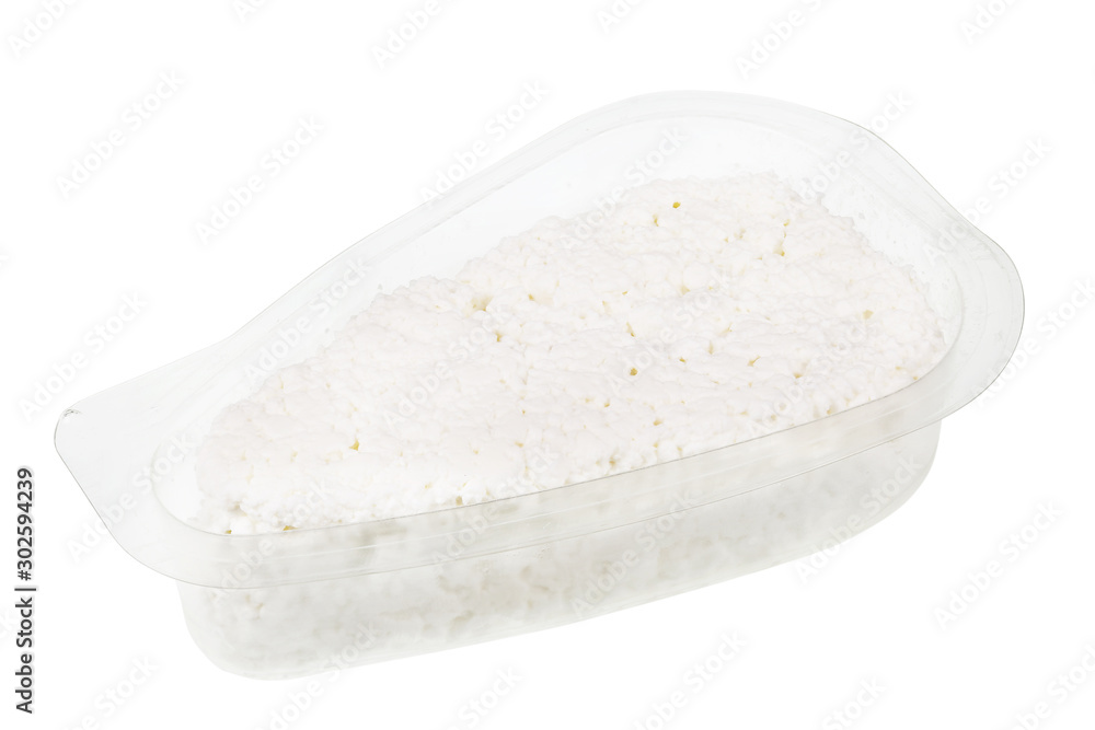 White soft curd cheese in an open transparent plastic container isolated macro White soft curd cheese in an open transparent plastic container isolated macro