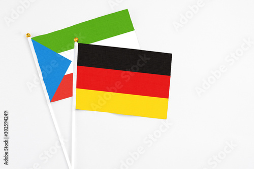 Germany and Equatorial Guinea stick flags on white background. High quality fabric  miniature national flag. Peaceful global concept.White floor for copy space.