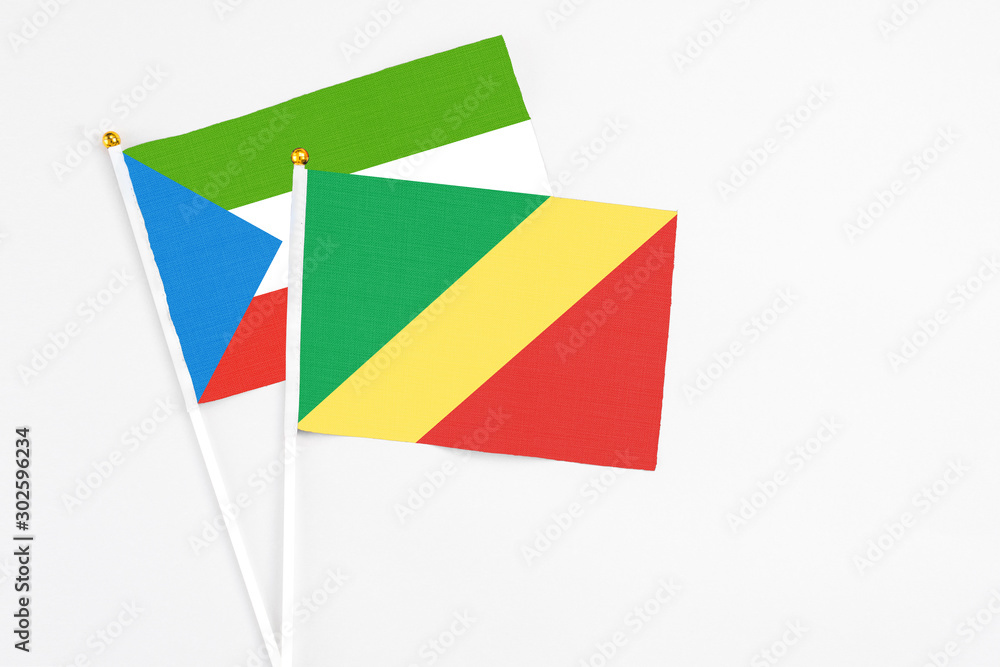 Republic Of The Congo and Equatorial Guinea stick flags on white background. High quality fabric, miniature national flag. Peaceful global concept.White floor for copy space.