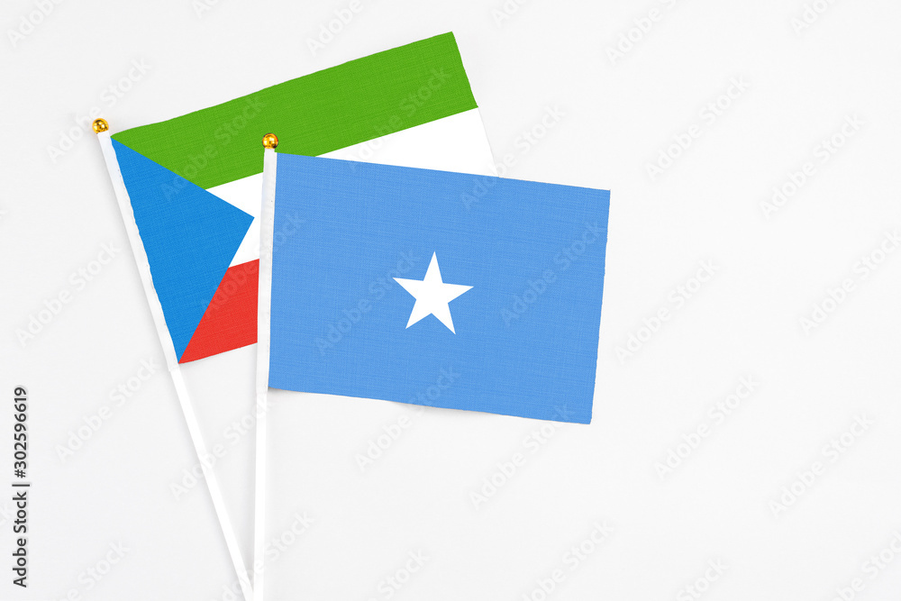 Somalia and Equatorial Guinea stick flags on white background. High quality fabric, miniature national flag. Peaceful global concept.White floor for copy space.