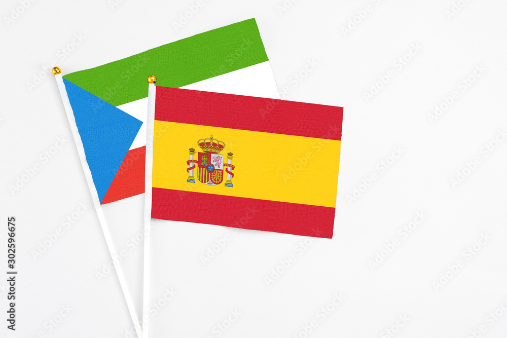 Spain and Equatorial Guinea stick flags on white background. High quality fabric, miniature national flag. Peaceful global concept.White floor for copy space. Spain and Equatorial Guinea stick flags on white background. High quality fabric, miniature national flag. Peaceful global concept.White floor for copy space.