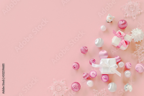 Christmas composition with giftboxes,ball ornaments,  and snowflakes on pastel pink background.  Flat lay, top view, copy space © nana77777