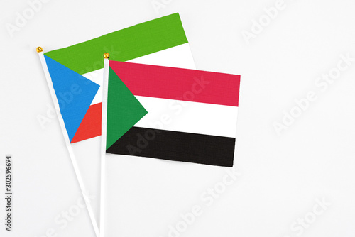 Free Download Sudan and Equatorial Guinea stick flags on white background. High quality fabric, miniature national flag. Peaceful global concept.White floor for copy space. - GFXLoad