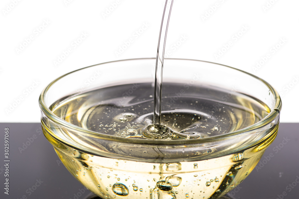 Pour sunflower oil into a napkin holder, flow and splash Pour sunflower oil into a napkin holder, flow and splash