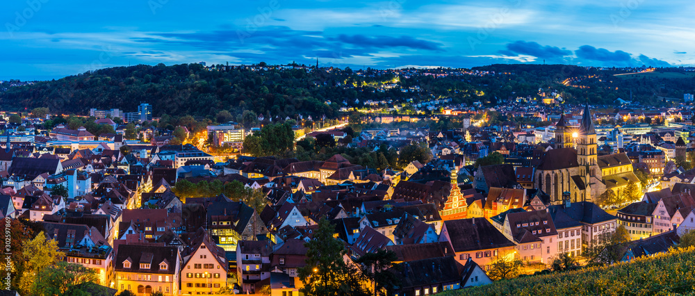 Obraz premium Germany, XXL panorama aerial view above skyline of medieval city esslingen am neckar, over roofs, houses, church and streets by night in magical twilight atmosphere