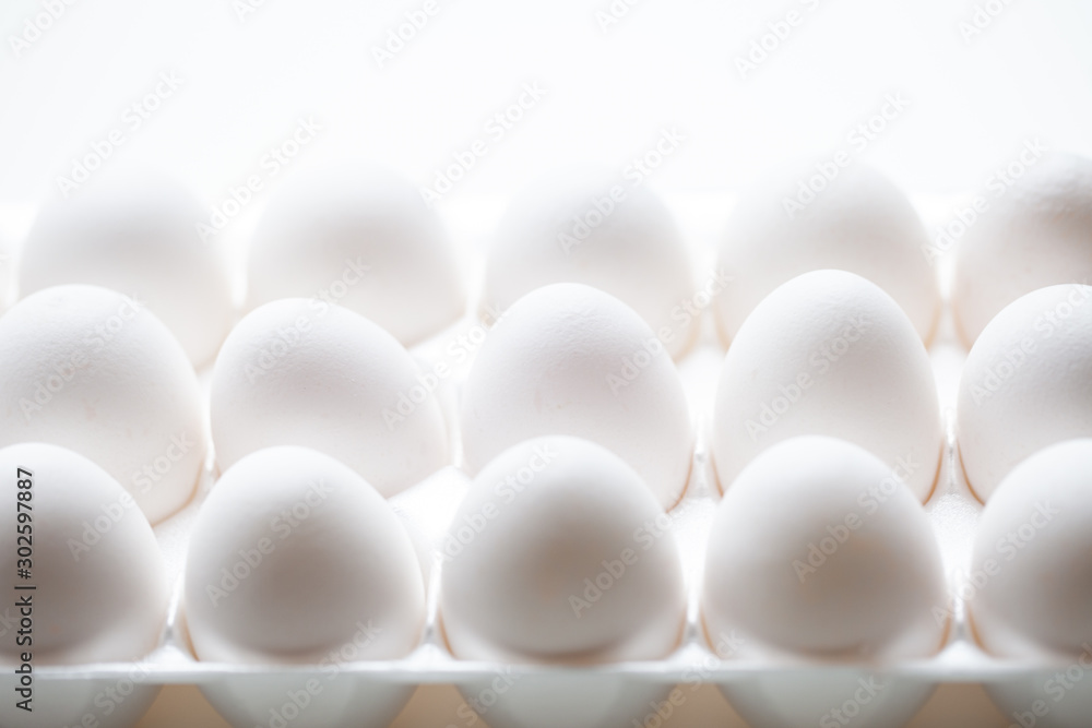 Alignment of white eggs in a foam egg case, close up view of eggs Alignment of white eggs in a foam egg case, close up view of eggs
