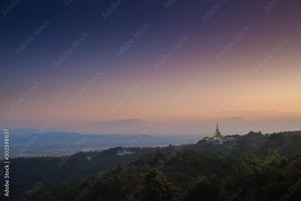 Mountain view evening of Crystal Pagoda or Chedi Kaew on top hill with purple sky background, twilight at Wat Tha Ton, Tha Ton, Fang, Chiang Mai, northern of Thailand.