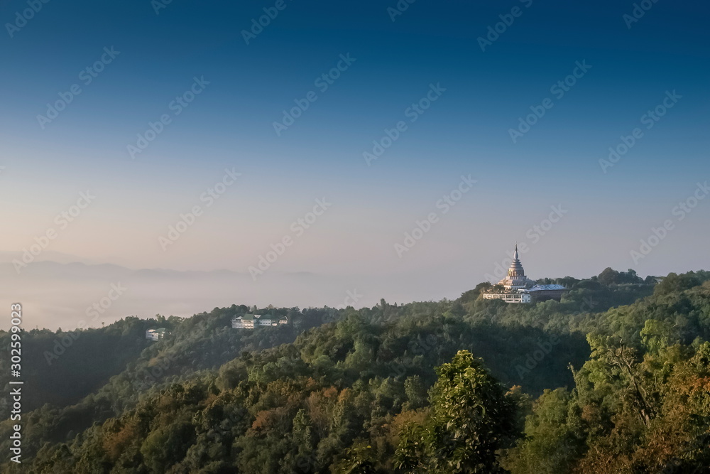 Mountain view morning of Crystal Pagoda or Chedi Kaew on top hill with blue sky background, sunrise at Wat Tha Ton, Tha Ton, Fang, Chiang Mai, northern of Thailand.