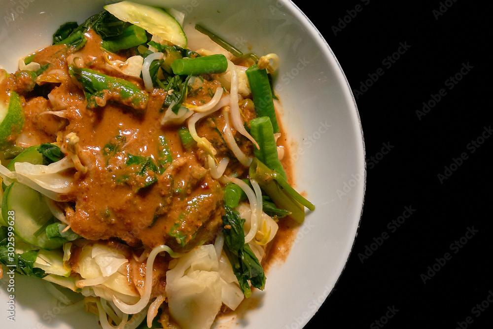 top view of gado gado, a indonesian food full of slice vegetables top view of gado gado, a indonesian food full of slice vegetables