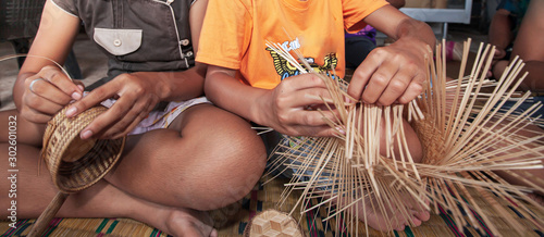 Obraz na plátně Two Asian girls made bamboo basketry.