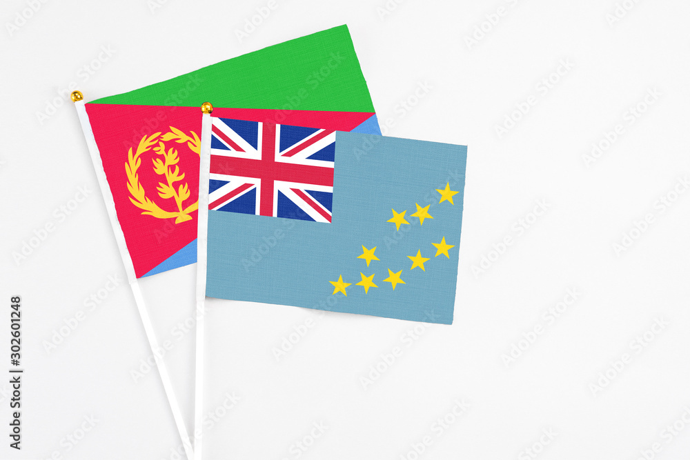 Tuvalu and Eritrea stick flags on white background. High quality fabric, miniature national flag. Peaceful global concept.White floor for copy space. Tuvalu and Eritrea stick flags on white background. High quality fabric, miniature national flag. Peaceful global concept.White floor for copy space.