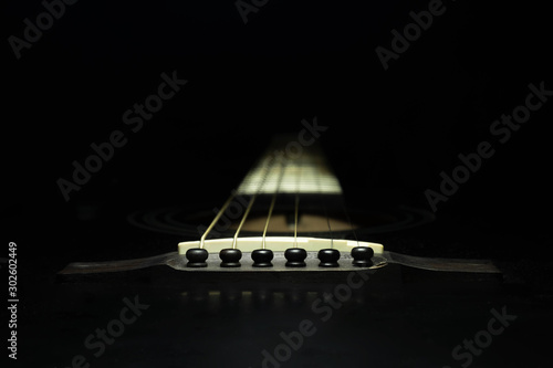 Obraz na plátně Black guitar on a dark background