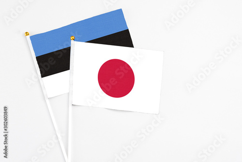 Japan and Estonia stick flags on white background. High quality fabric, miniature national flag. Peaceful global concept.White floor for copy space. Free Download Japan and Estonia stick flags on white background. High quality fabric, miniature national flag. Peaceful global concept.White floor for copy space. - GFXLoad