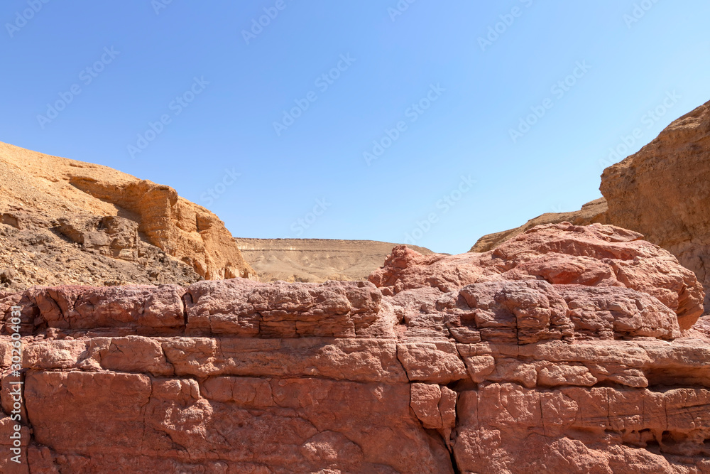 Spectacular layered surfaces of stone mountains in the Red Slot Canyon. Tourism Israel