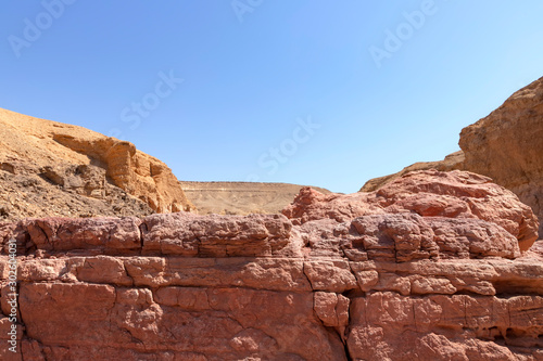 Spectacular layered surfaces of stone mountains in the Red Slot Canyon. Tourism Israel