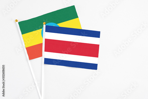Free Download Costa Rica and Ethiopia stick flags on white background. High quality fabric, miniature national flag. Peaceful global concept.White floor for copy space. - GFXLoad