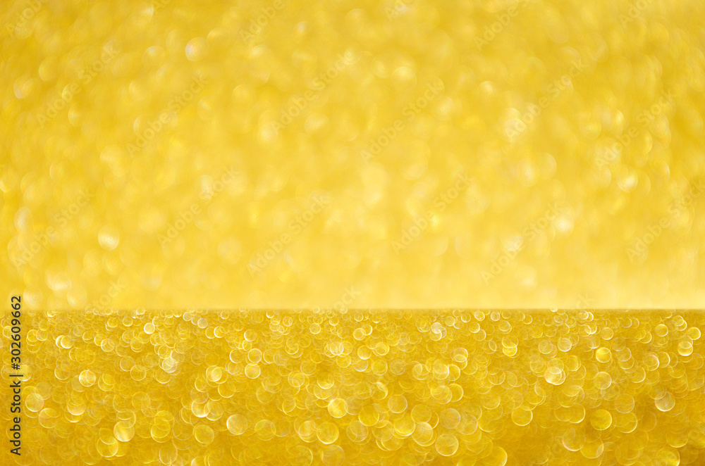 Golden glittering glowing bokeh background with blur. Golden glittering glowing bokeh background with blur.