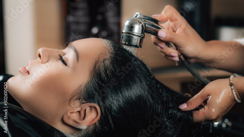 Hairdresser Rinsing Woman’s Hair.