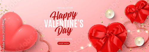 Valentine's Day banner for seasonal sale. Vector illustration with realistic red gift boxes, sparkling light garland, candles, air balloon and confetti on pink background. Promo discount banner.