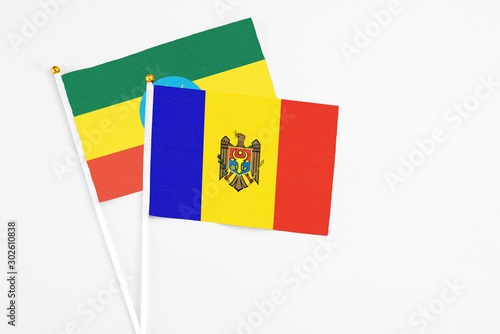Moldova and Ethiopia stick flags on white background. High quality fabric  miniature national flag. Peaceful global concept.White floor for copy space.