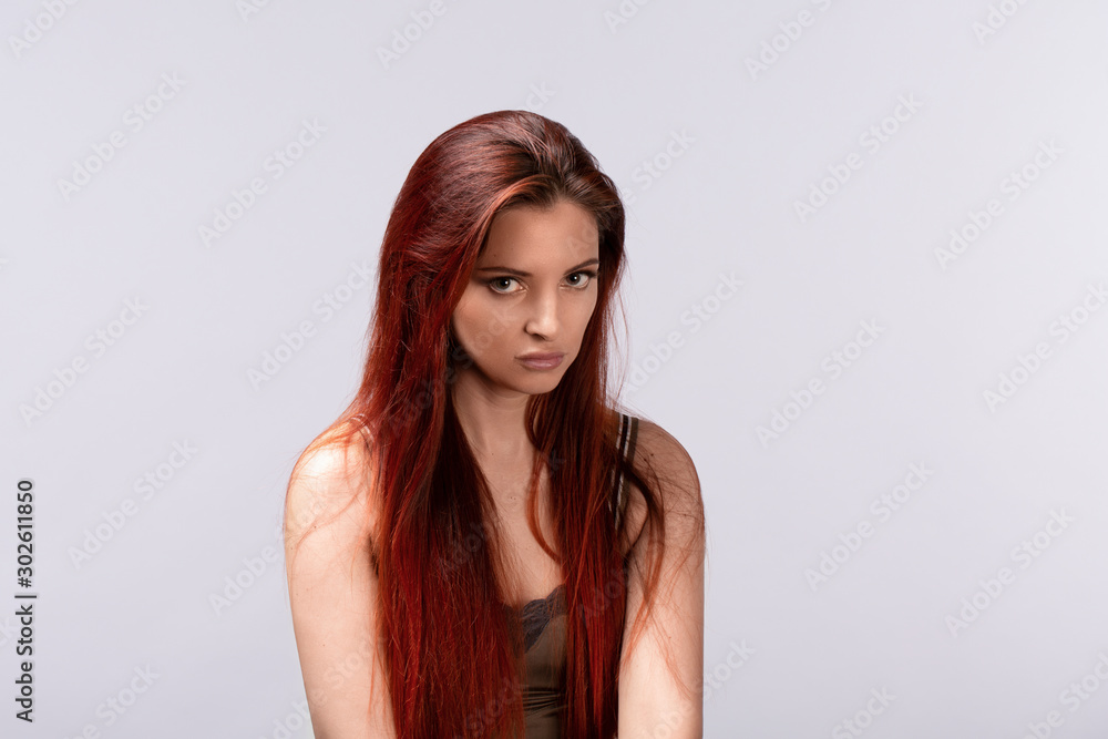 Portrait of Young offended female on light background Portrait of Young offended female on light background