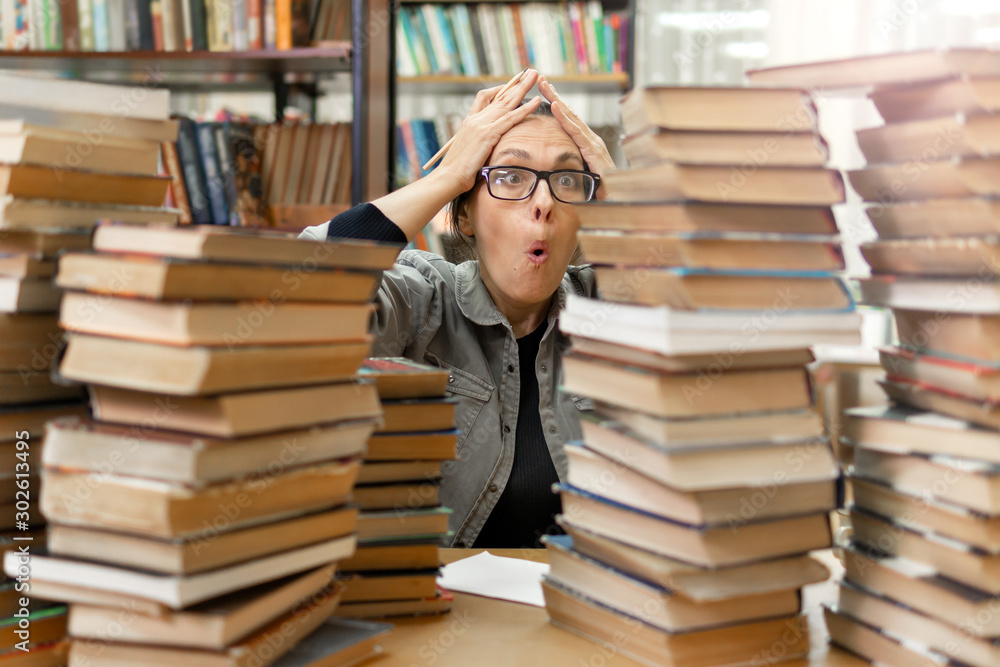 woman in the library in front of bookshelves. Concept of education woman in the library in front of bookshelves. Concept of education