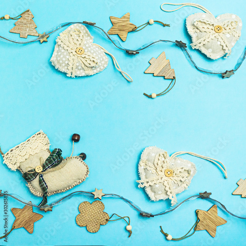 Rustic Handmade Christmas decorationson from natural materials  and garland on a blue background with copy space. The concept of the new year, christmas and winter holidays.Flat lay, top view. photo