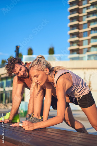 Modern couple doing exercise in urban area.