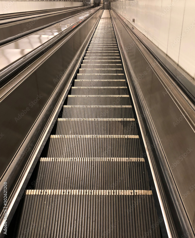 Empty Long Escalator Moving Up and Down to/from The Metro or Underground Train Station at Night used as Template for Mock up or Background Texture Empty Long Escalator Moving Up and Down to/from The Metro or Underground Train Station at Night used as Template for Mock up or Background Texture