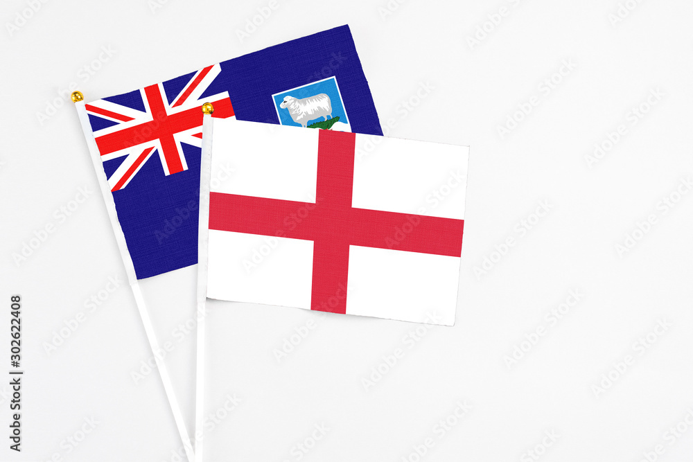 England and Falkland Islands stick flags on white background. High quality fabric, miniature national flag. Peaceful global concept.White floor for copy space.