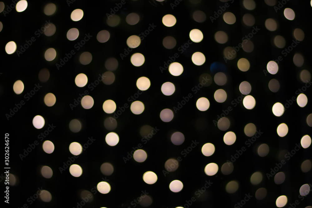 Golden bokeh on a black background, blurred lights Golden bokeh on a black background, blurred lights